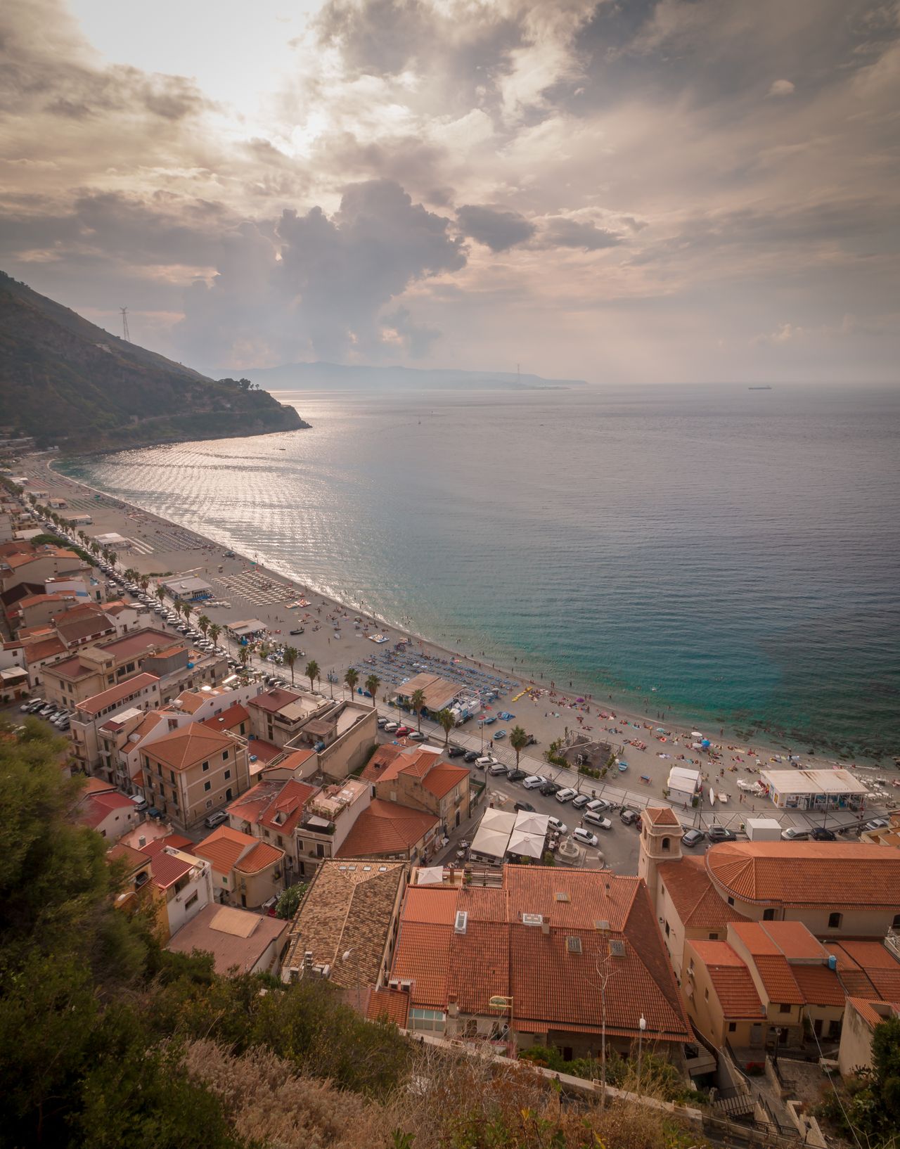 Aerial view of coastal town of Scilla with colourful buildings above turquoise sea, Calabria, southern Italy