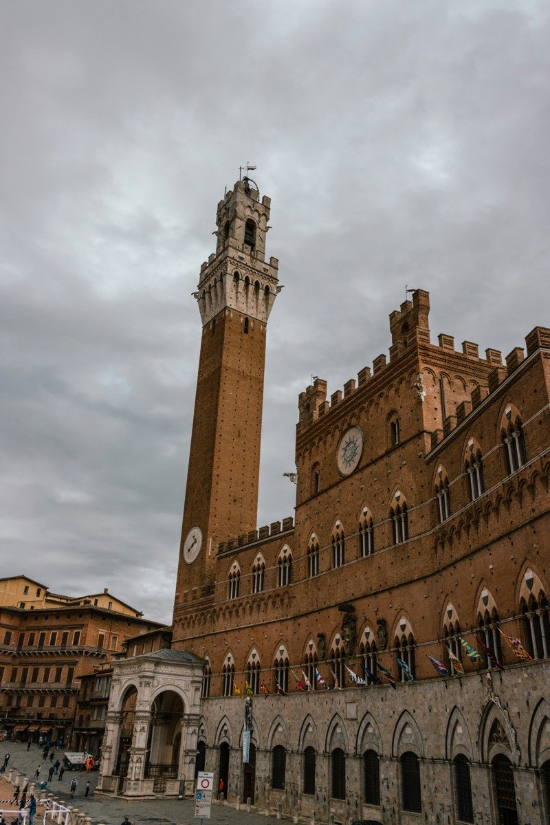 Torre del Mangia and Palazzo Pubblico rising above Piazza del Campo, Siena, Tuscany, Italy