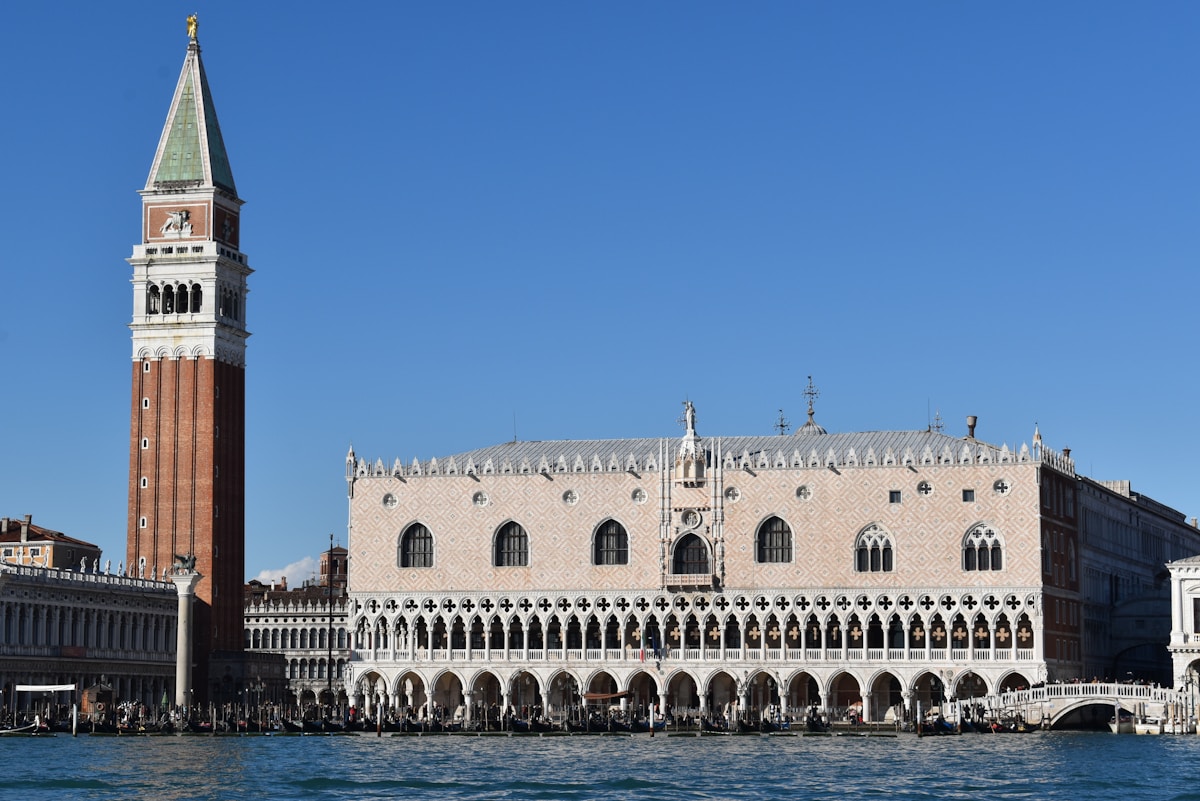 Doge's Palace Gothic facade with St. Mark's Campanile, Venice, Italy, seen from the lagoon