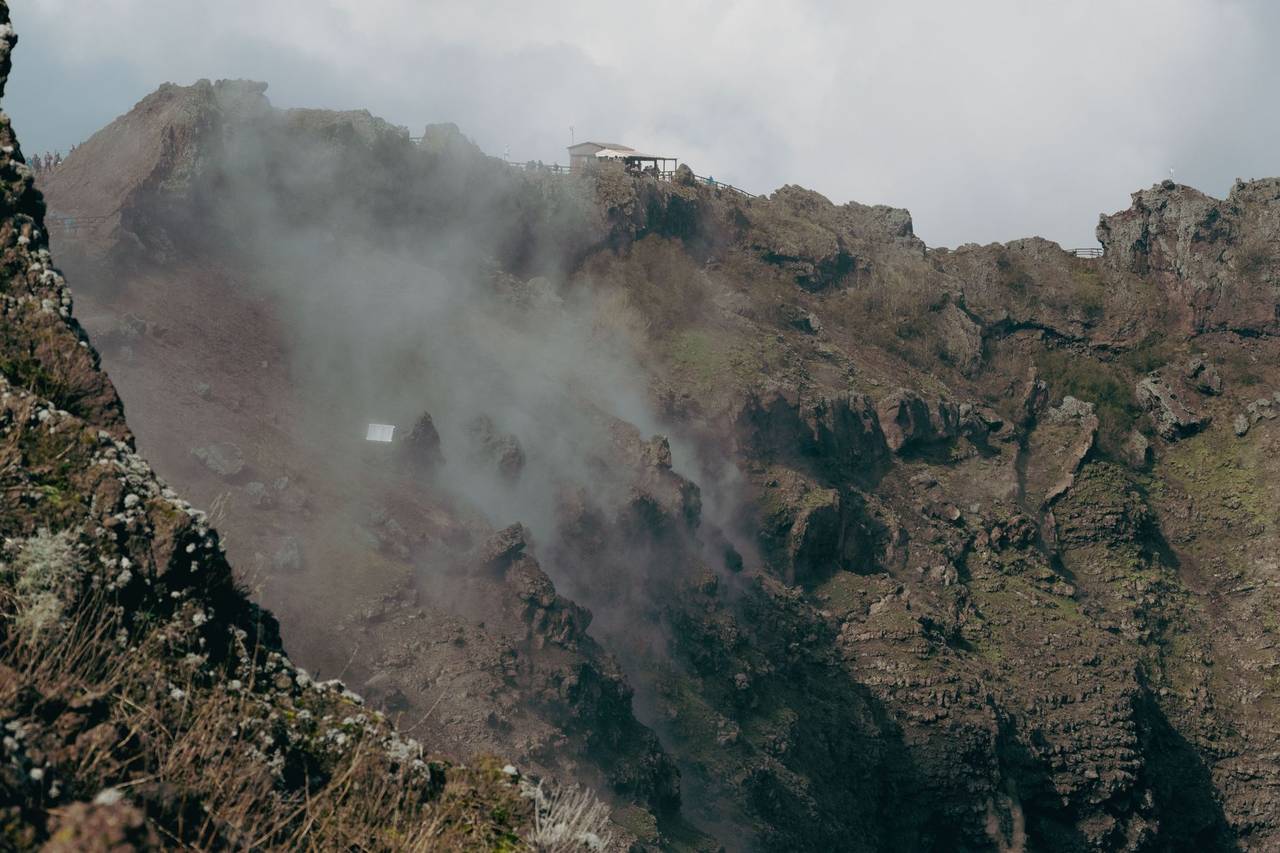 Steaming volcanic crater of Mount Vesuvius with rocky walls, Naples, Campania, Italy