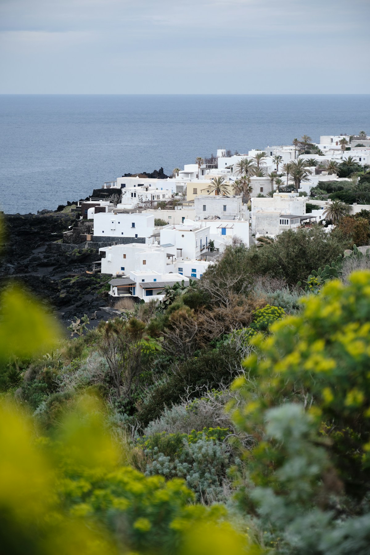 View of a white village on a volcanic cliff near the ocean, Stromboli, Aeolian Islands, Italy