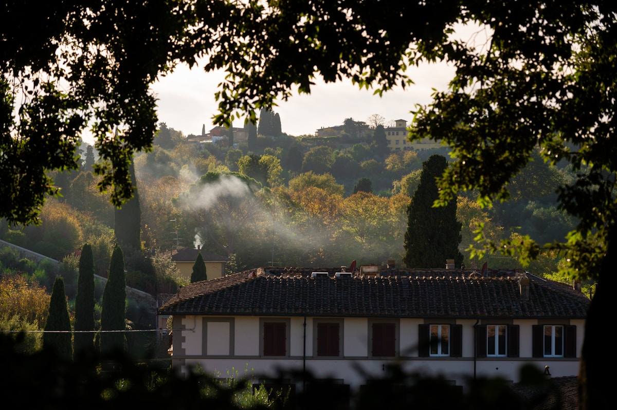 Tuscan villa with rolling hills and distant town, near Bologna area, Italy