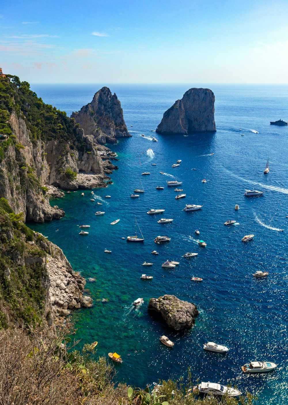 Faraglioni rock stacks rising dramatically from the sea, Capri, Bay of Naples, Italy