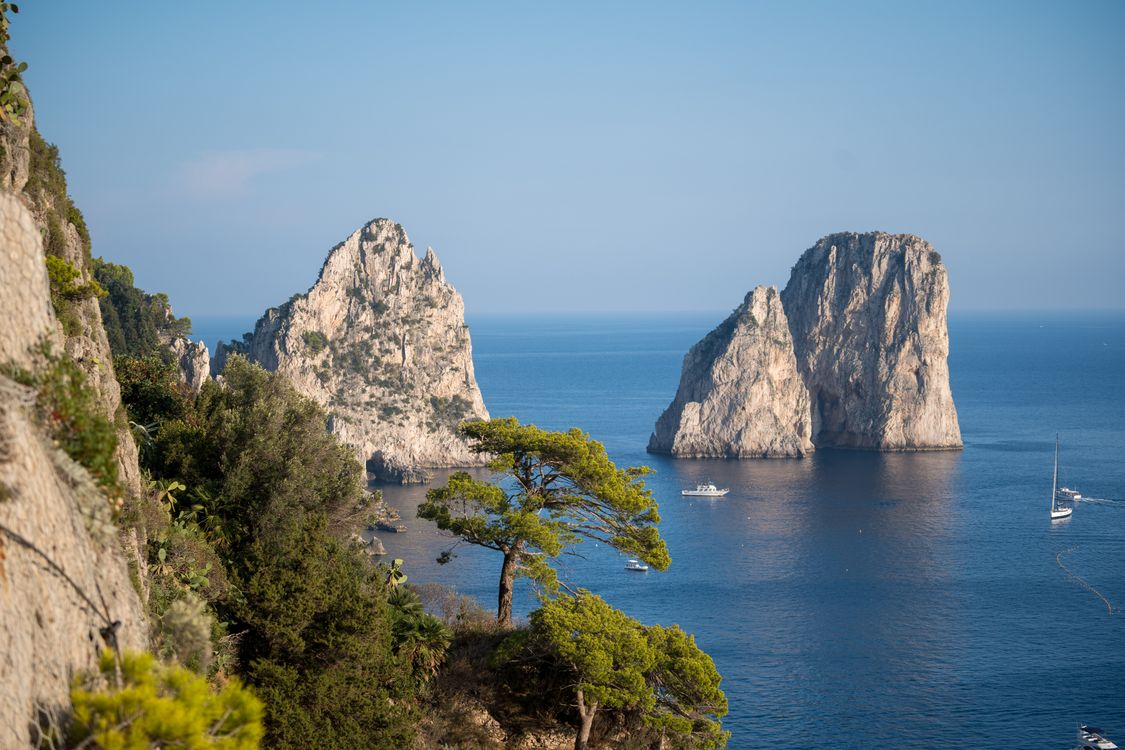Aerial view of Capri's Faraglioni sea stacks and rocky coastline in the Bay of Naples, Italy