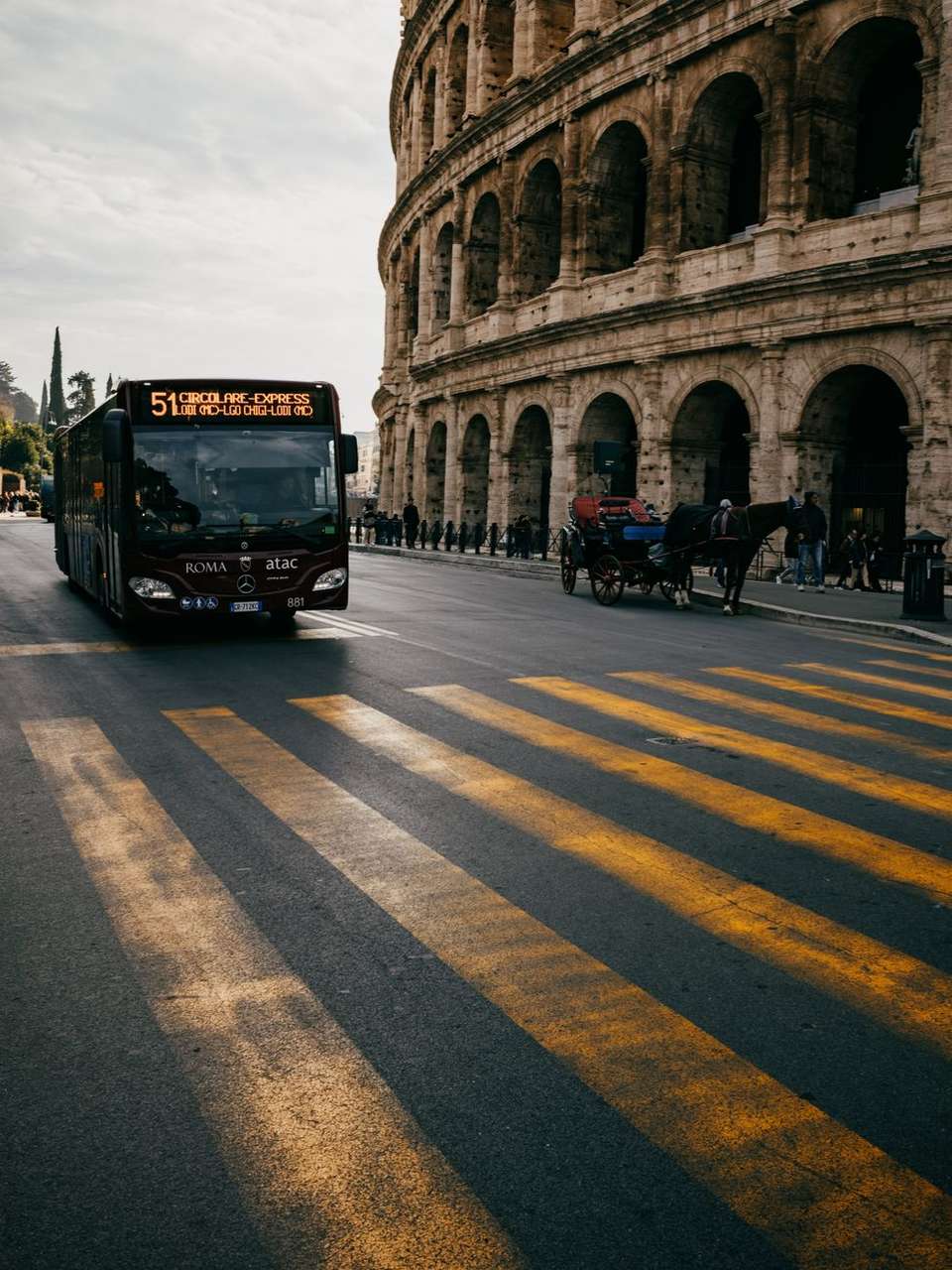 Rome ATAC public bus passing the Colosseum, Rome, Italy