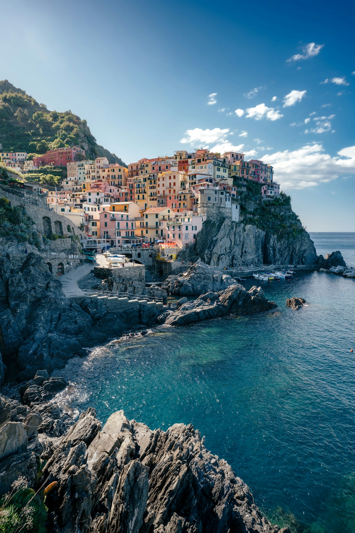 Colourful houses stacked on a rocky cliff above the turquoise Ligurian Sea, Manarola, Cinque Terre