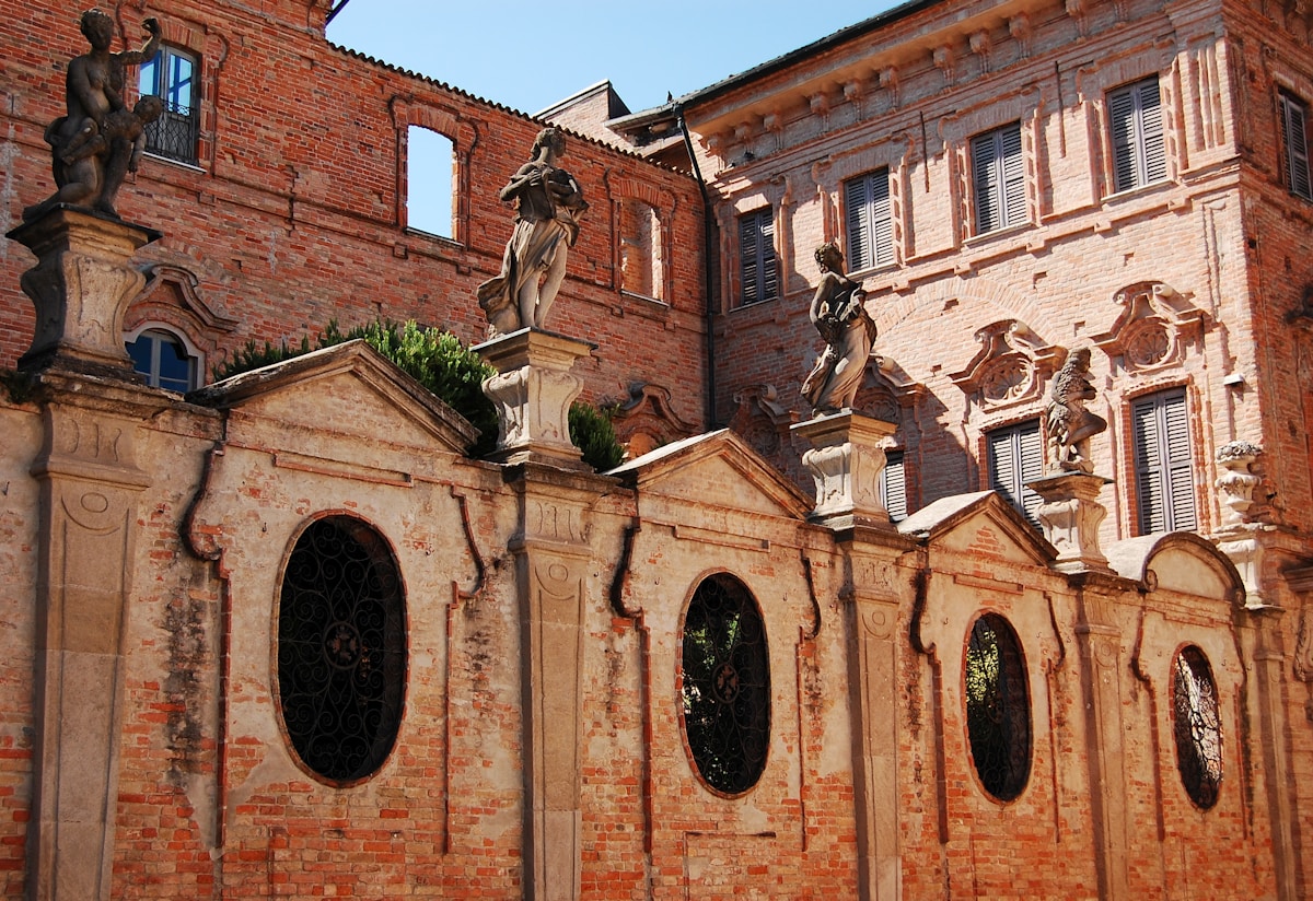 Baroque building facade with statues, historic centre of Cremona, Lombardy, Italy