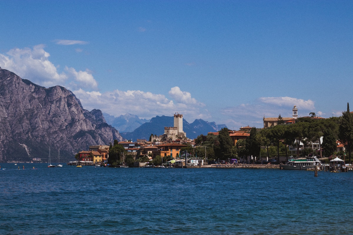 Malcesine town and castle on Lake Garda with Alpine mountains behind, Italy