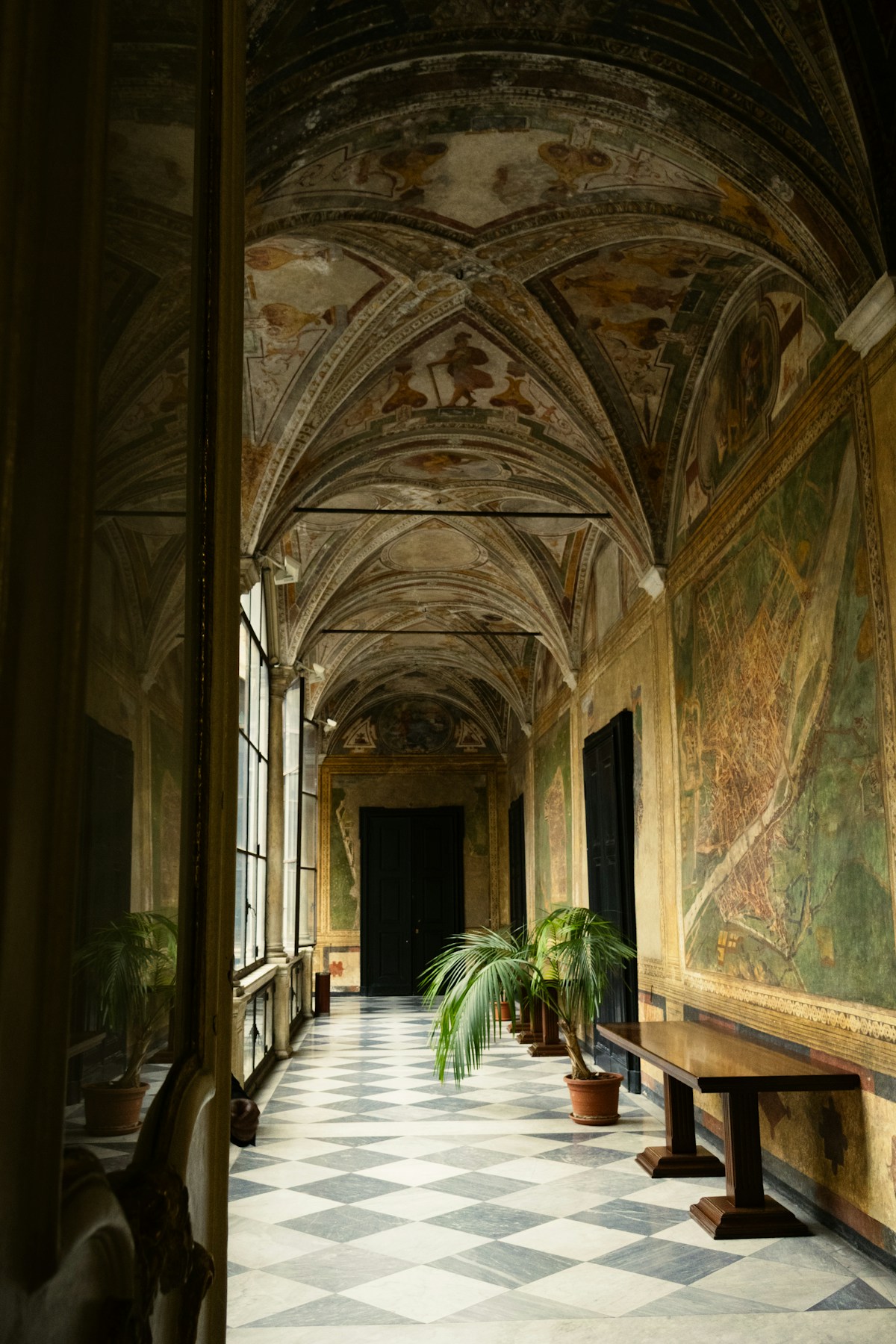Frescoed vaulted corridor with checkered marble floor in a Genoese Rolli palace, Genoa, Italy