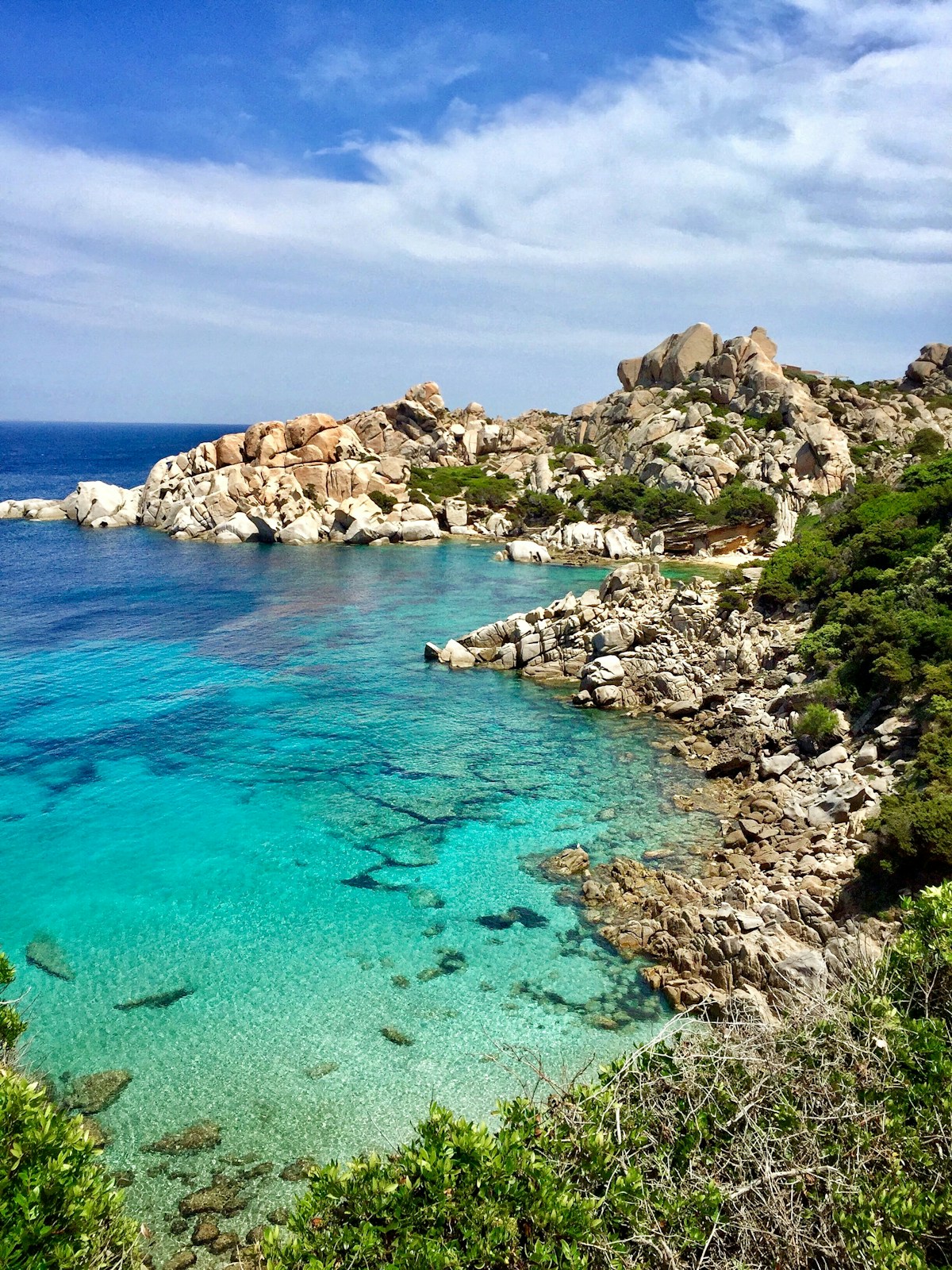 Body of water surrounded by trees and rocks, Santa Teresa di Gallura, Sardinia, Italy