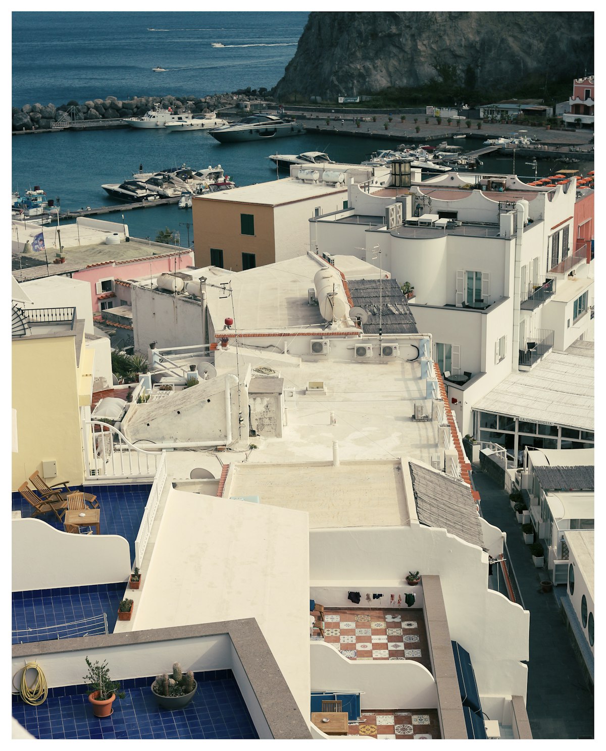 Aerial view of Ischia town with harbour and boats, Bay of Naples, Italy