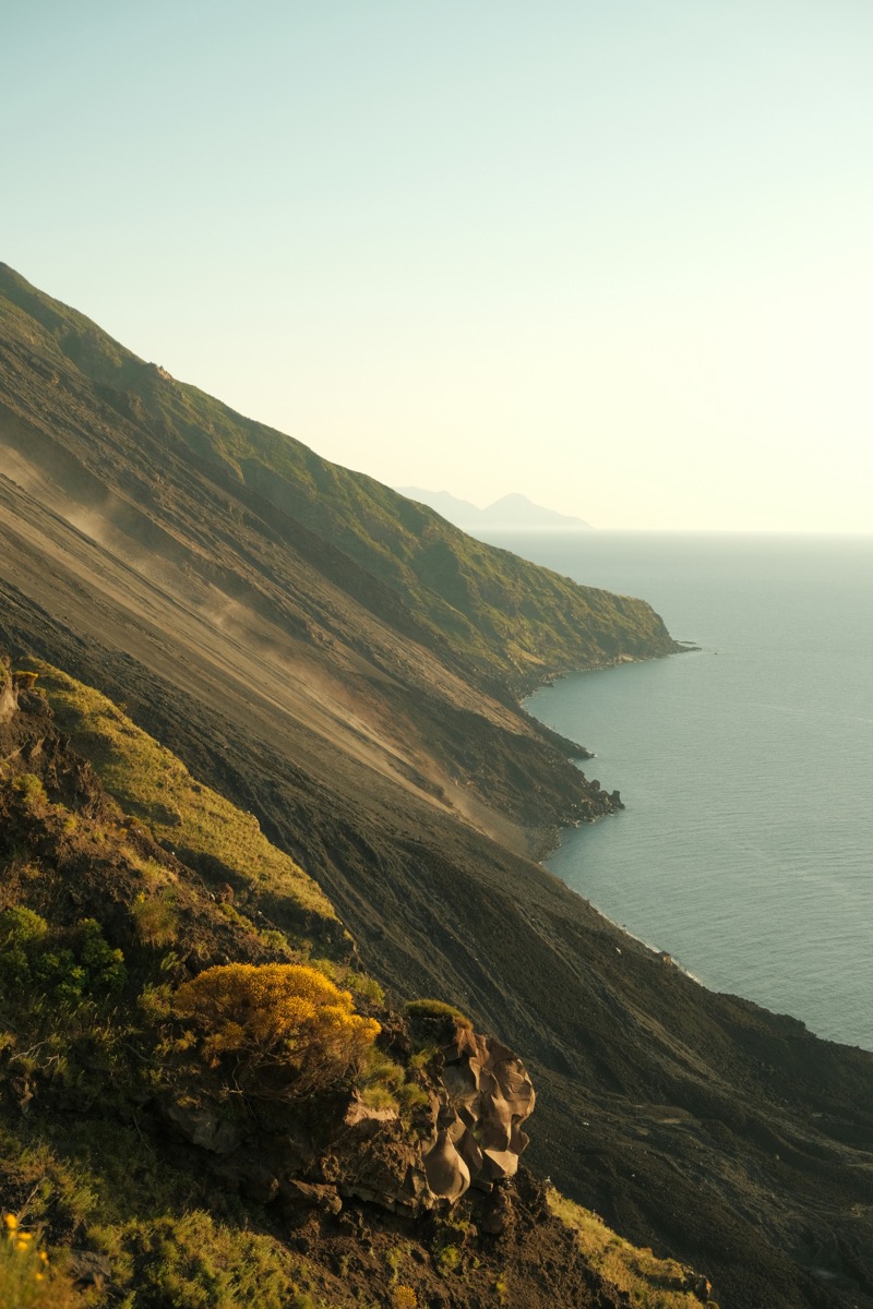 Steep volcanic hillside of Stromboli dropping to the Tyrrhenian Sea at dusk, Aeolian Islands, Italy