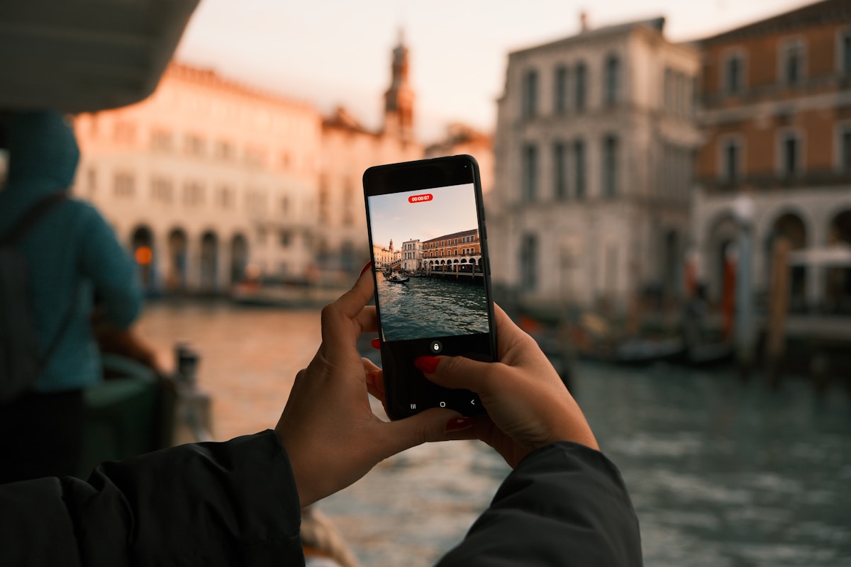 Smartphone with eSIM app open at the Colosseum in Rome, Italy