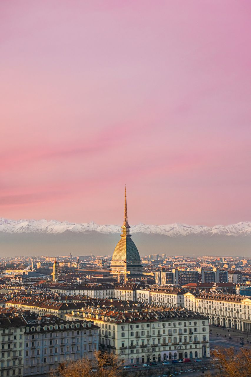 Turin skyline with the Mole Antonelliana and snow-capped Alps at sunset