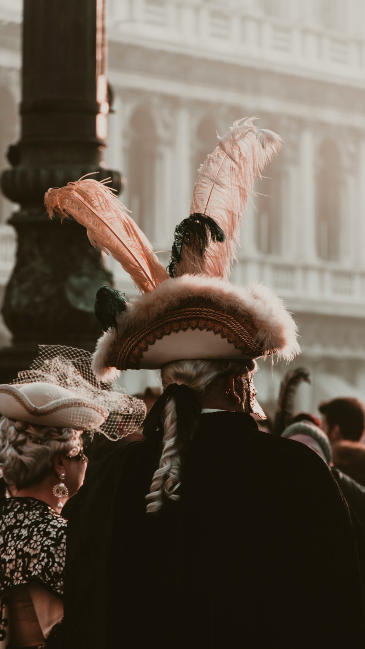 People in elaborate period costumes at Venice Carnival, St Mark's Square, Italy