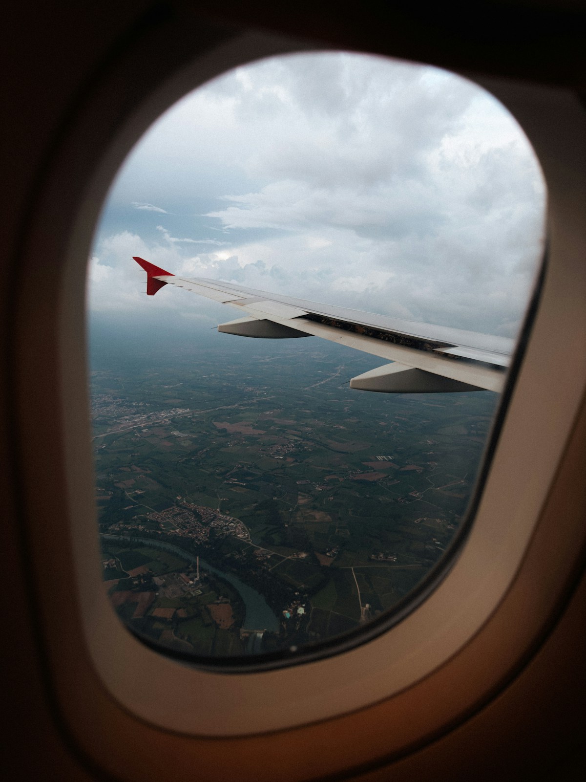 View of airplane wing from window, flying to Italy