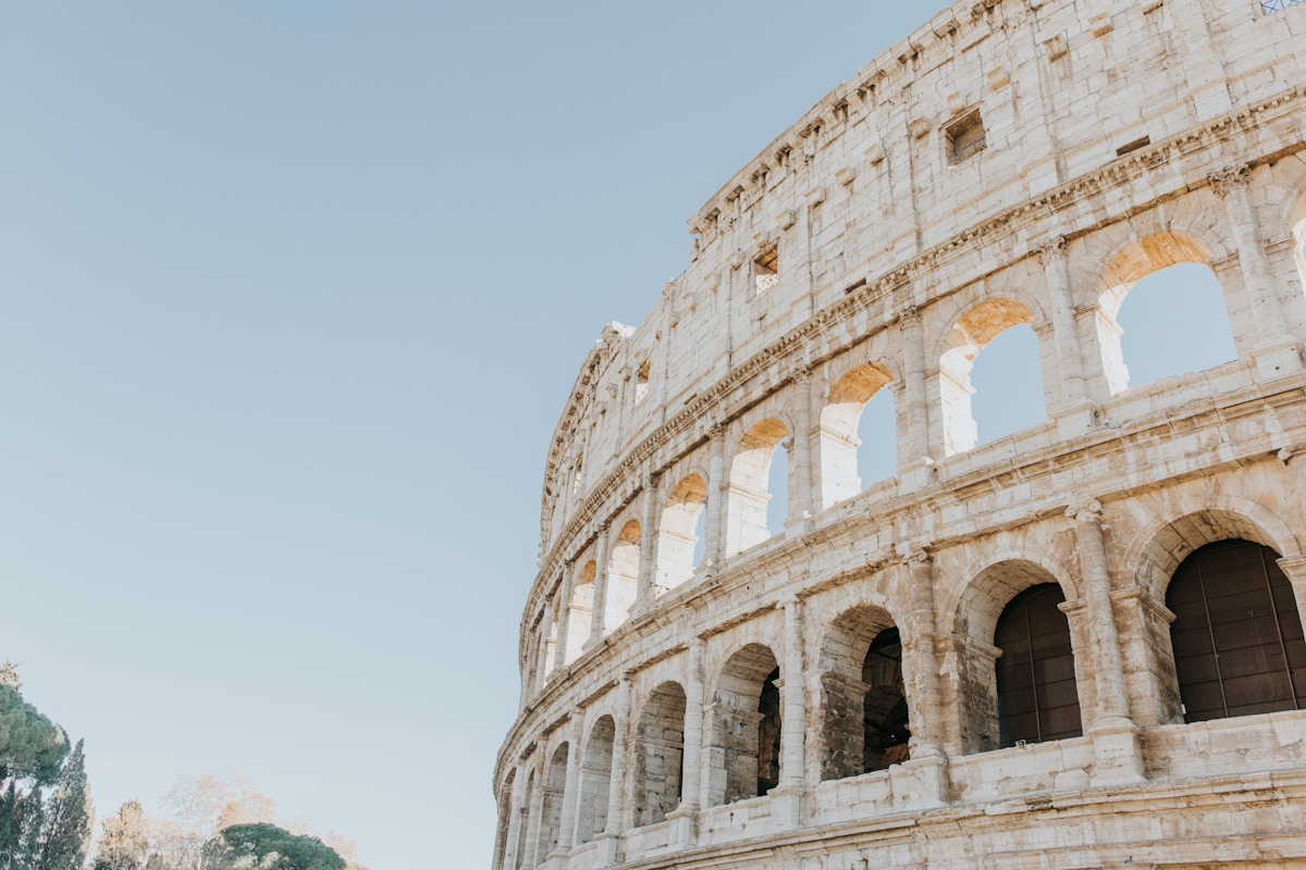 Exterior arches of the Colosseum against a clear sky, Rome, Italy