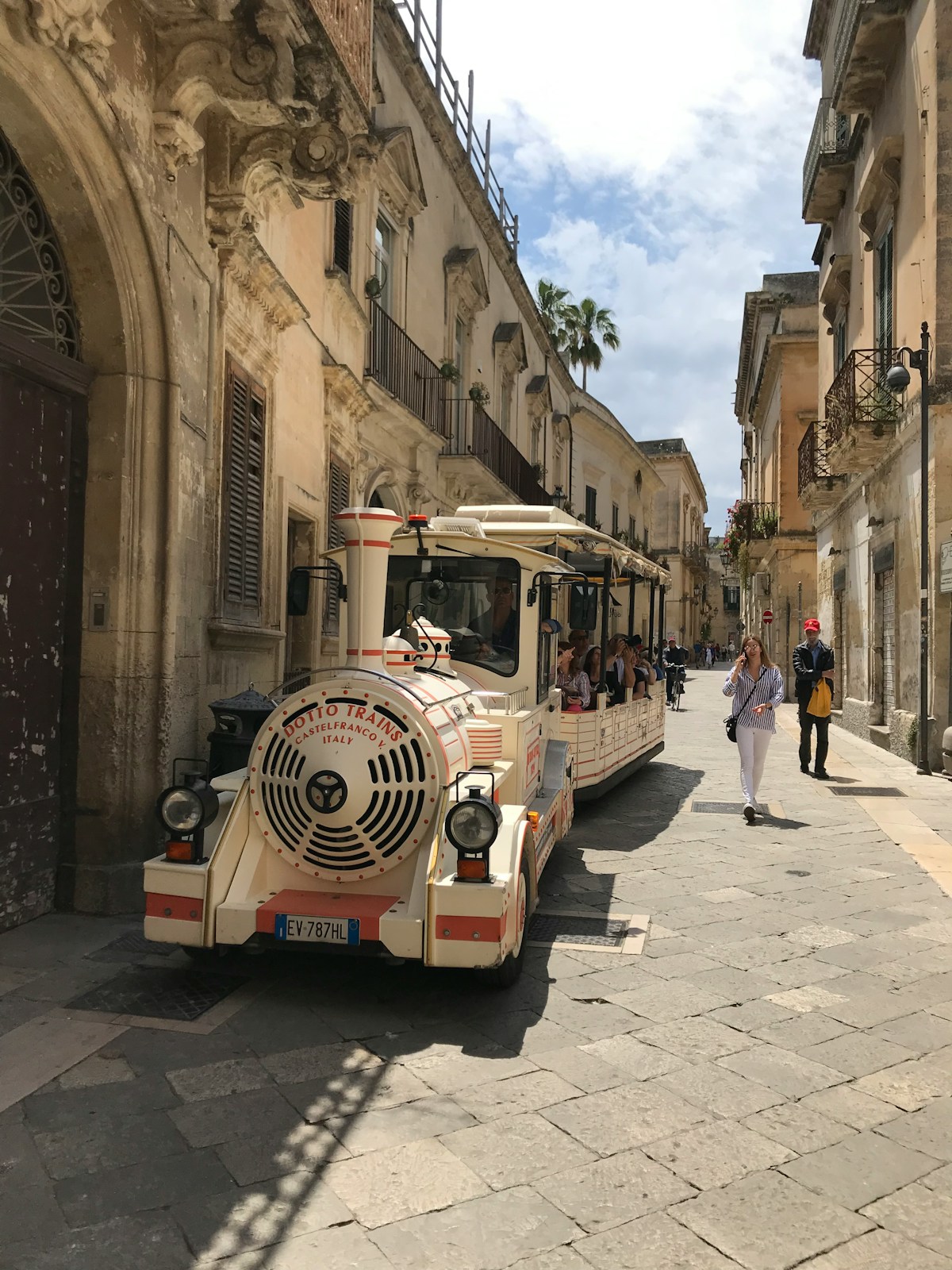 People on road beside buildings during golden hour, Lecce, Puglia, Italy