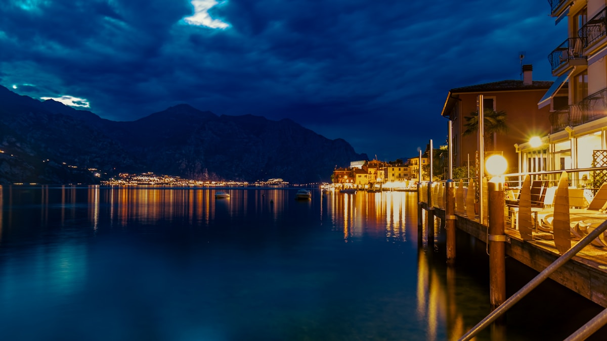 Malcesine lakefront and mountains at night, Lake Garda, Veneto, Italy