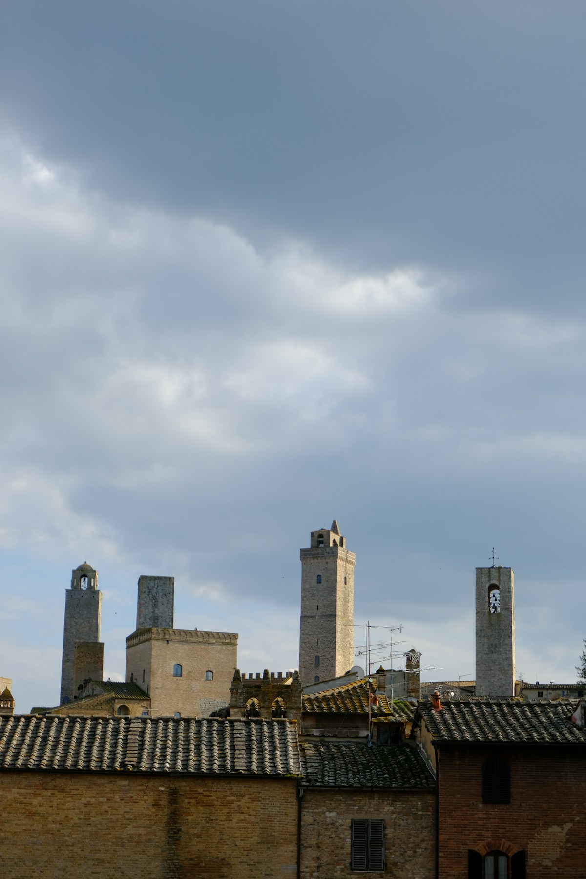 Medieval towers rise above tiled rooftops, San Gimignano, Tuscany, Italy