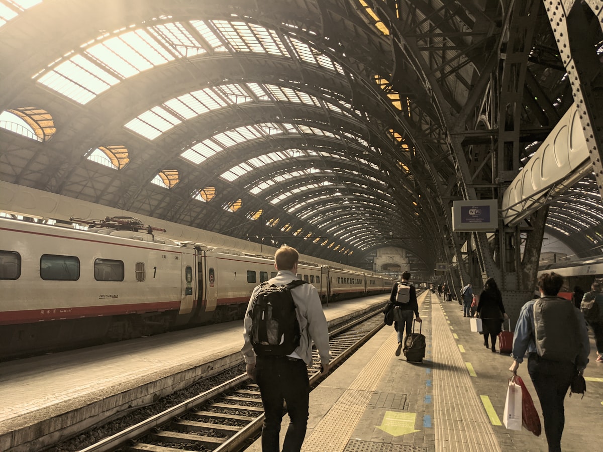 Travellers on the platform at Milano Centrale train station, Milan