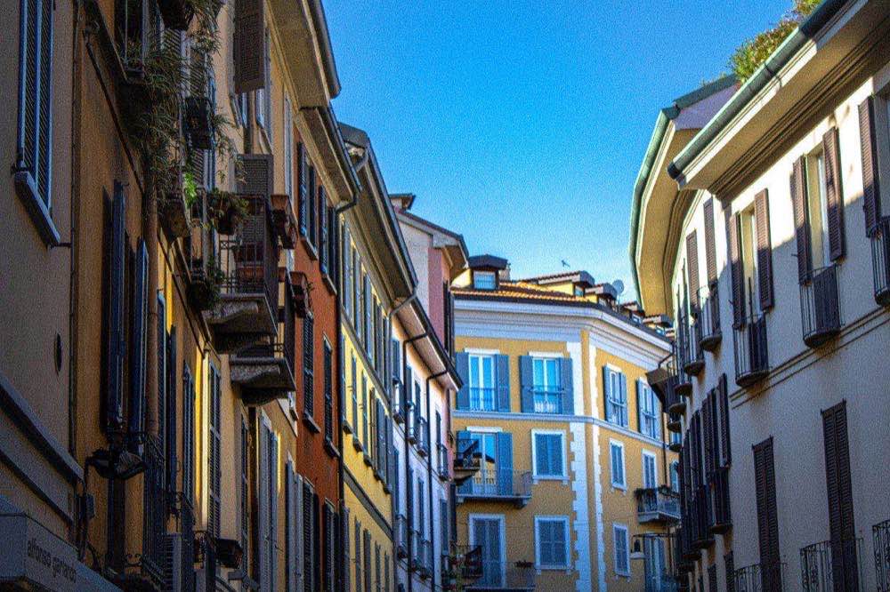Colourful Milanese apartment buildings with balconies on a residential street in Milan