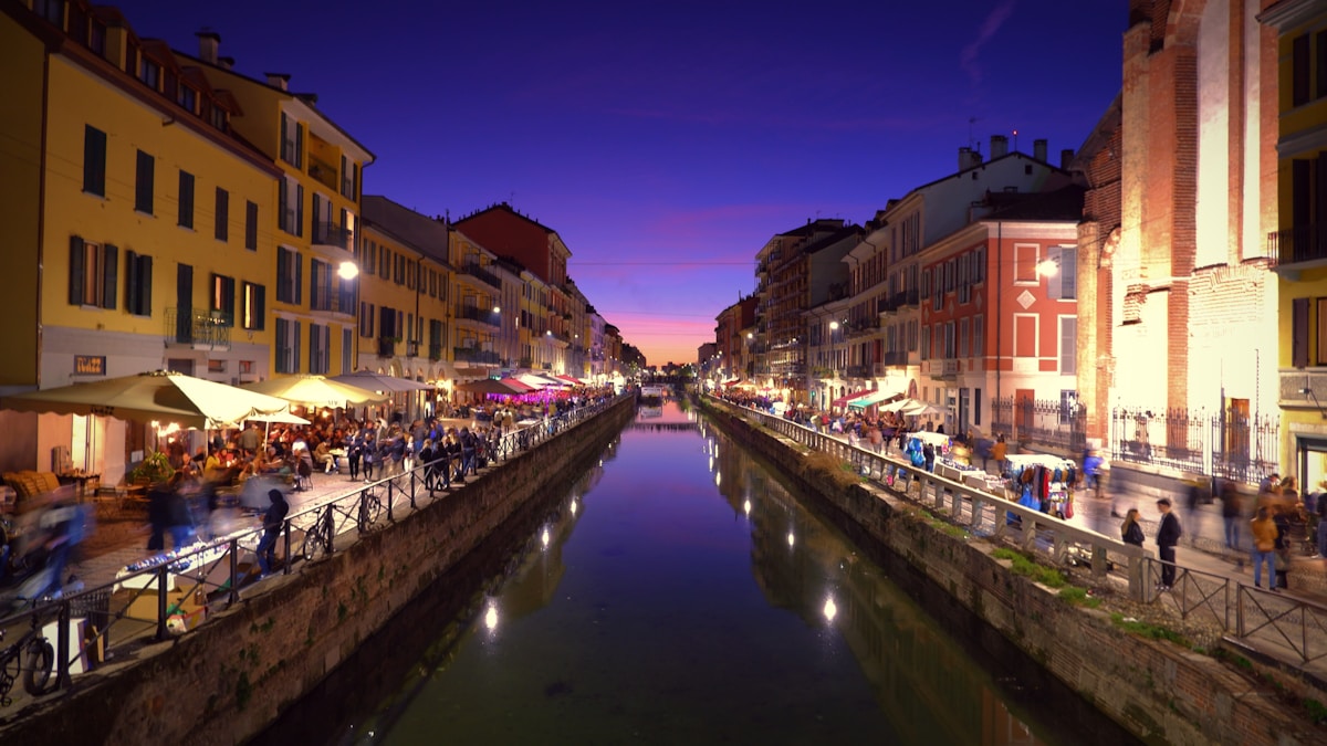 Naviglio Grande canal at dusk with bars and restaurants on both banks, Navigli district, Milan