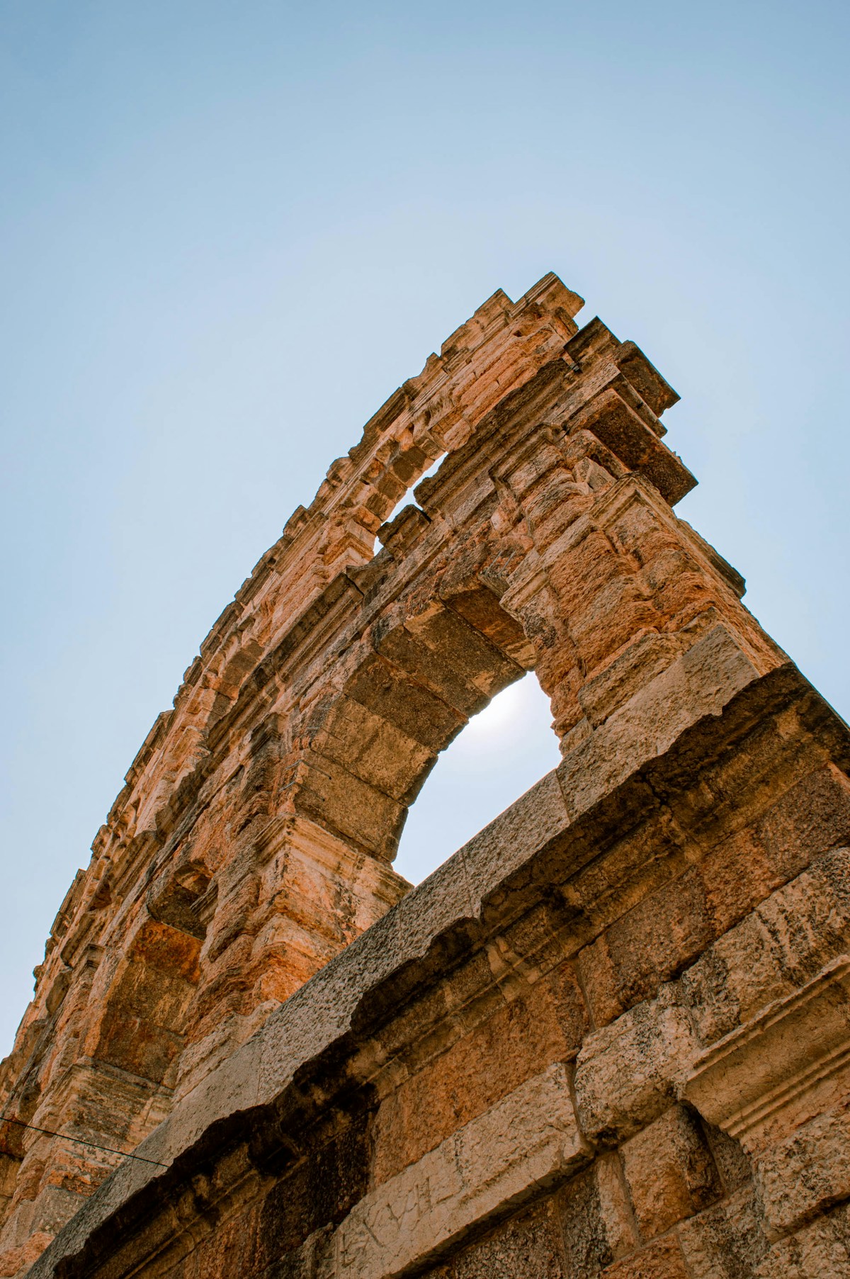 Ancient Roman ruins wall under blue sky, Milan area, Italy