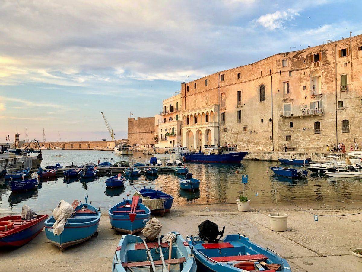 Traditional fishing boats in Monopoli harbour at sunset, Puglia, Italy