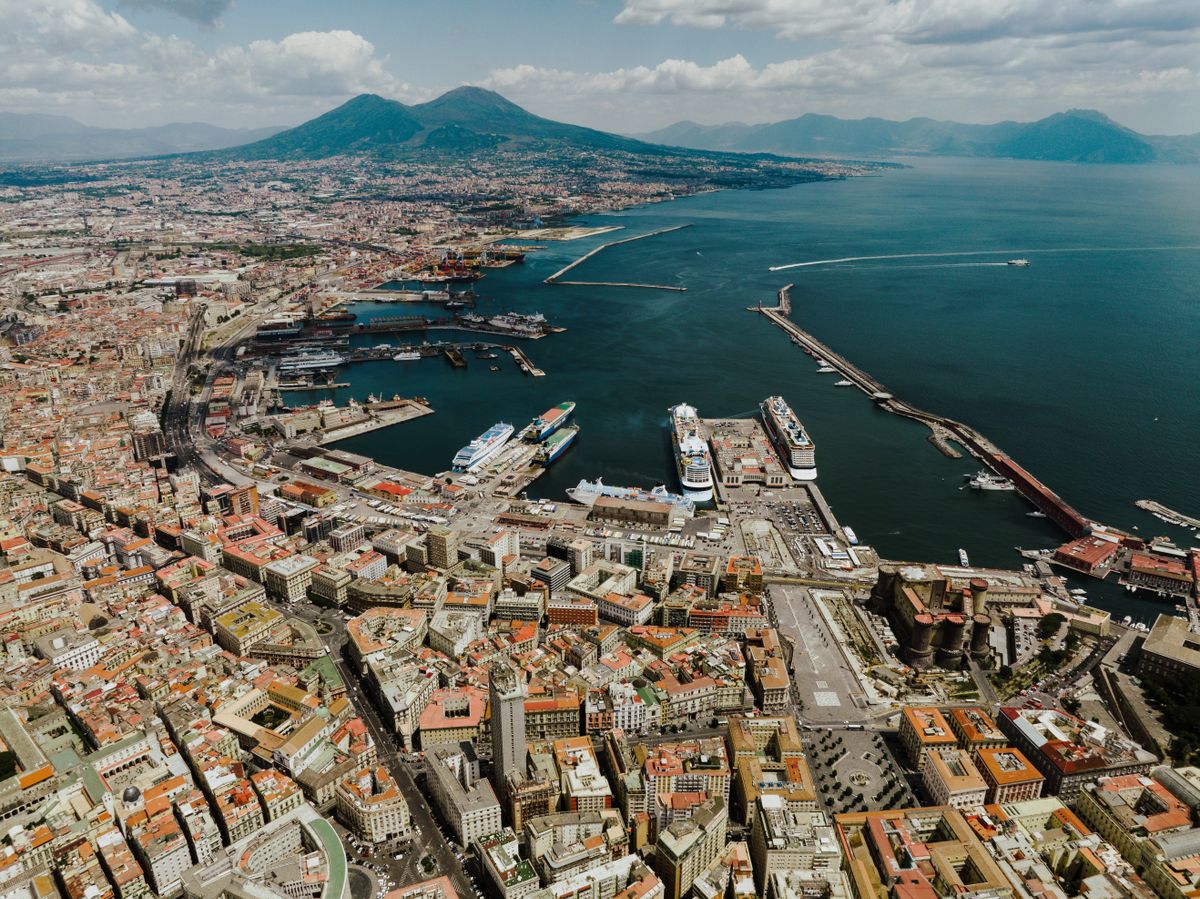 Aerial view of Naples city with the port and Mount Vesuvius in the background, Campania, Italy