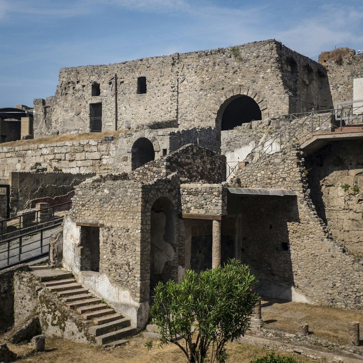 Ancient stone ruins and archways at the archaeological site of Pompeii, Italy