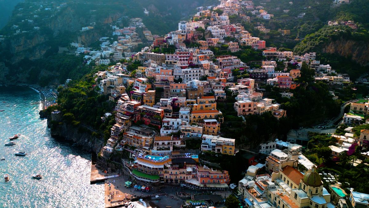Aerial view of Positano's colorful houses cascading down cliffs to the sea, Amalfi Coast, Italy