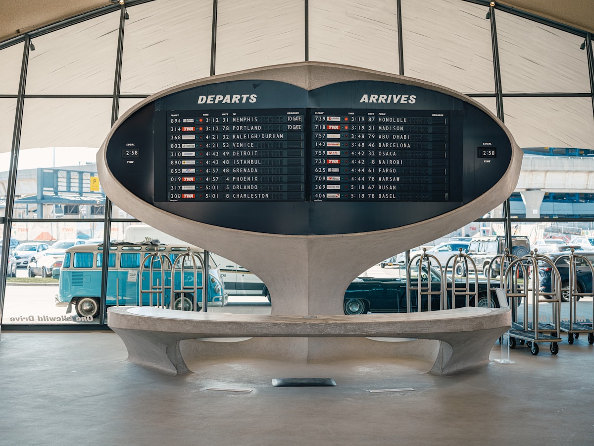 Airport departures timetable showing flight status, Italy border checks