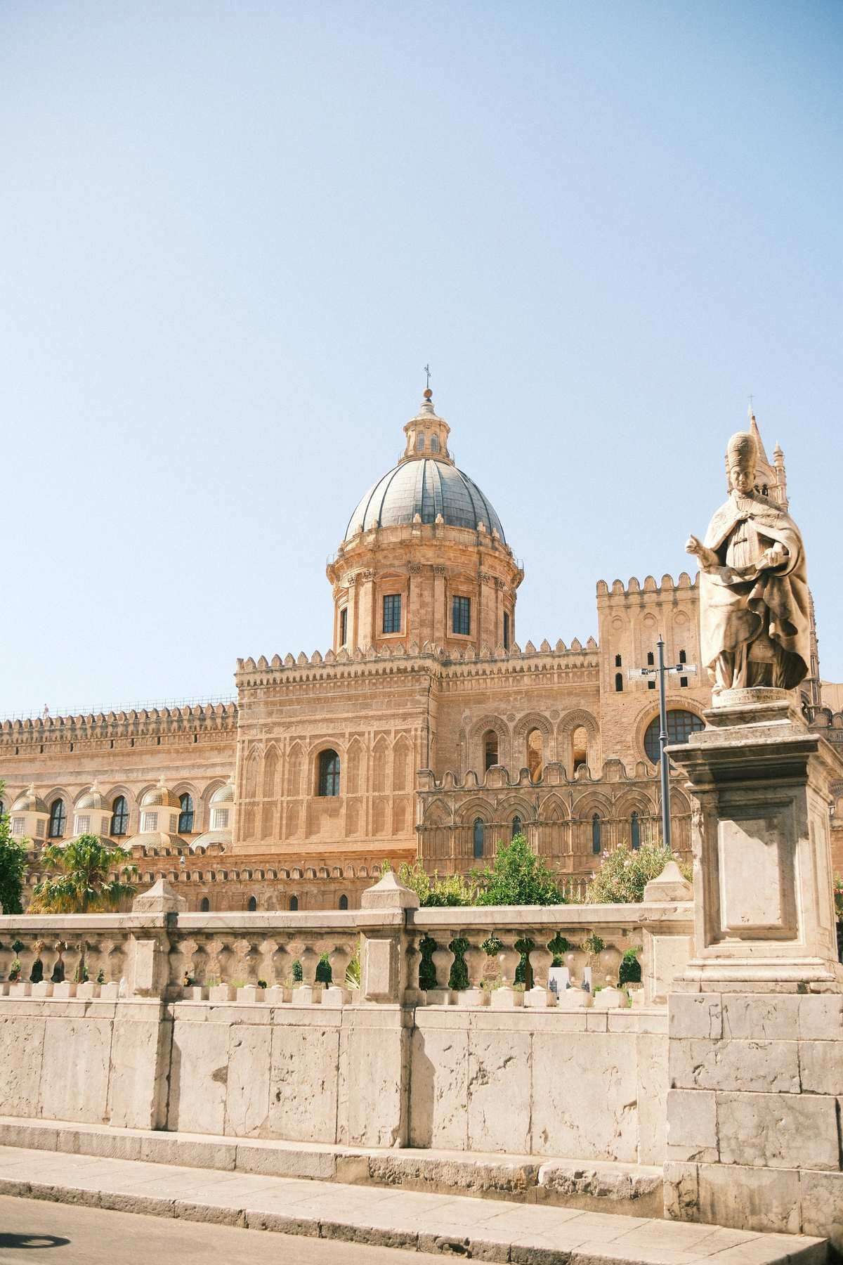 Cathedral of Palermo with its Norman-Arab dome and baroque stone statue in the foreground, Sicily, Italy