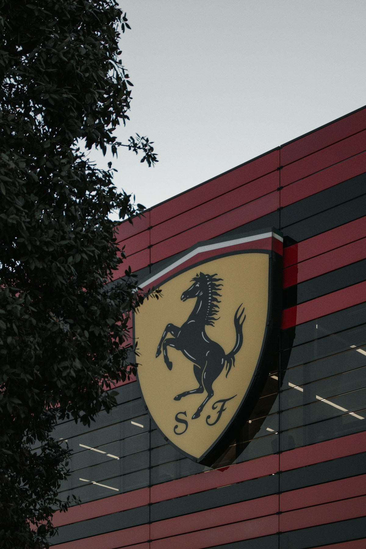 Ferrari Scuderia logo on the factory building at Maranello near Modena, Emilia-Romagna, Italy