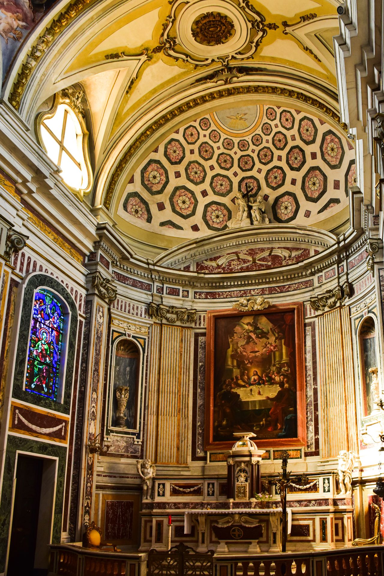 Ornate baroque church interior in Italy with gilded ceiling and altar