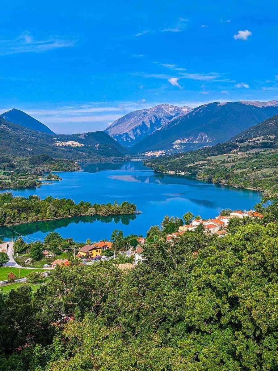 Barrea village and turquoise lake surrounded by Apennine mountains, Abruzzo National Park, Italy