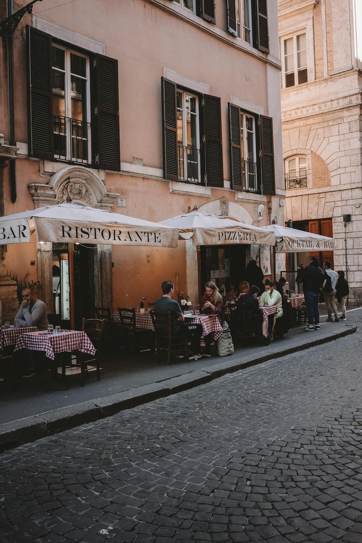 People sitting outside a restaurant, Rome, Italy