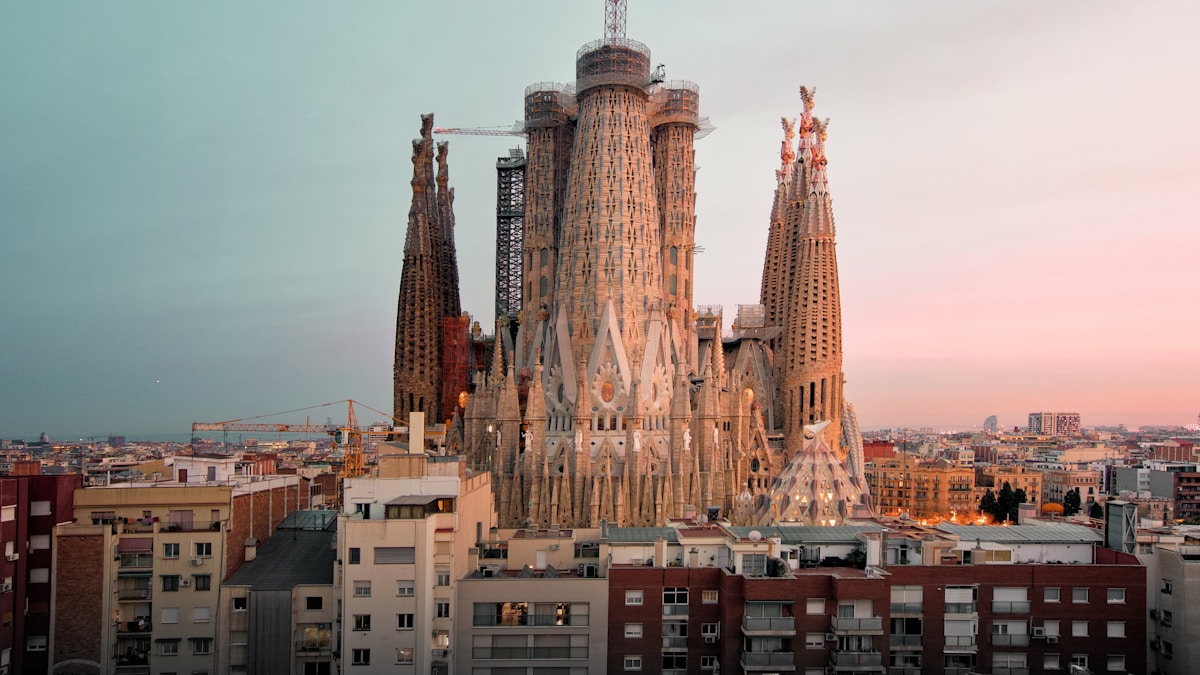 Sagrada Familia basilica at golden hour against the Barcelona skyline, Spain
