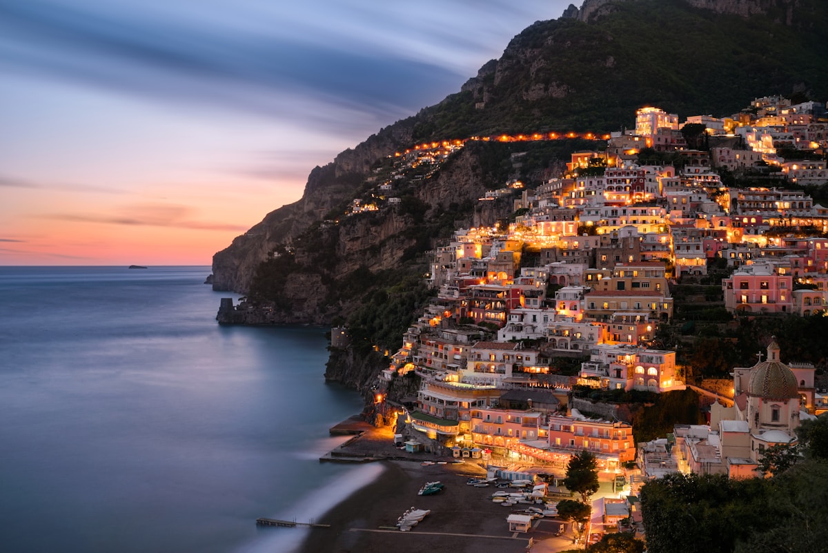 Coastal city buildings on mountain near body of water, Salerno area, Italy