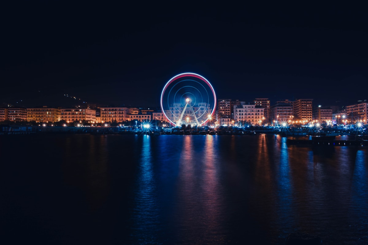 Salerno waterfront with ferris wheel at night, Campania, Italy