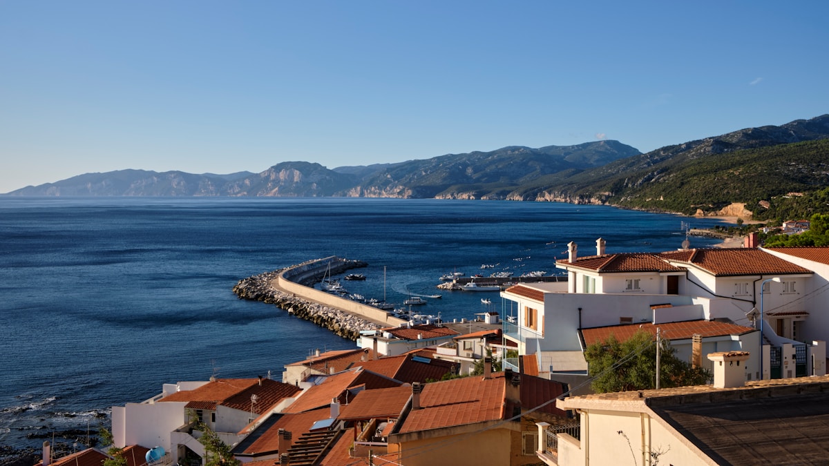 Body of water with houses and mountains, Cala Gonone, Sardinia, Italy