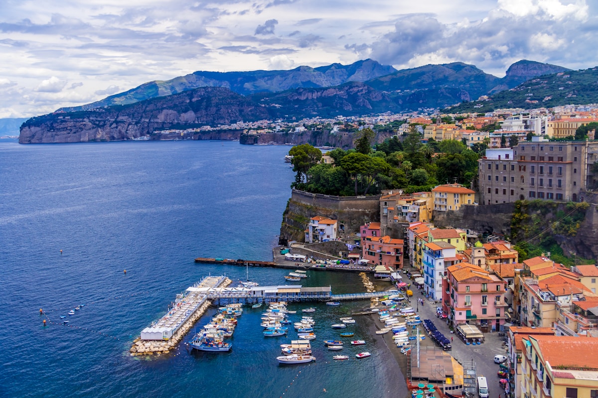 Aerial view of Sorrento clifftop town above the Bay of Naples with mountains behind, Campania, Italy