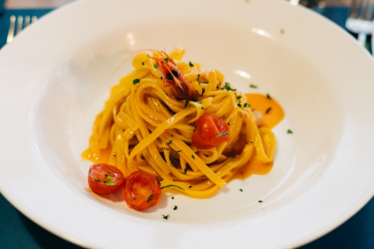 Plate of linguine with shrimp and cherry tomatoes, Italian coastal seafood pasta