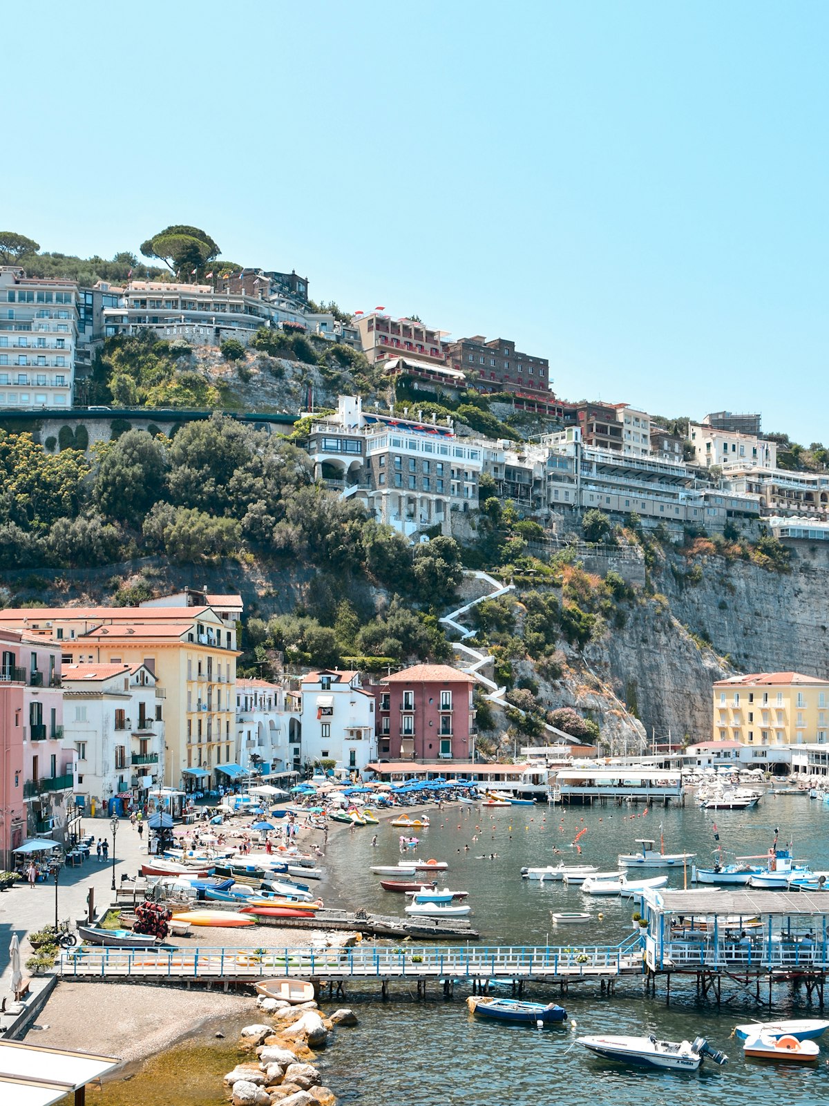 Sorrento harbour with boats, cliffs, and pastel buildings, Campania, Italy