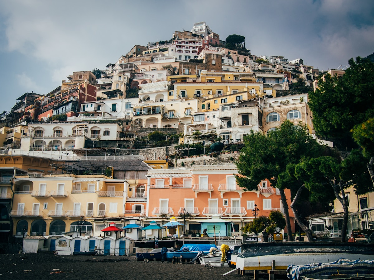 Positano's terraced buildings above the beach — heart of the southern Italy itinerary