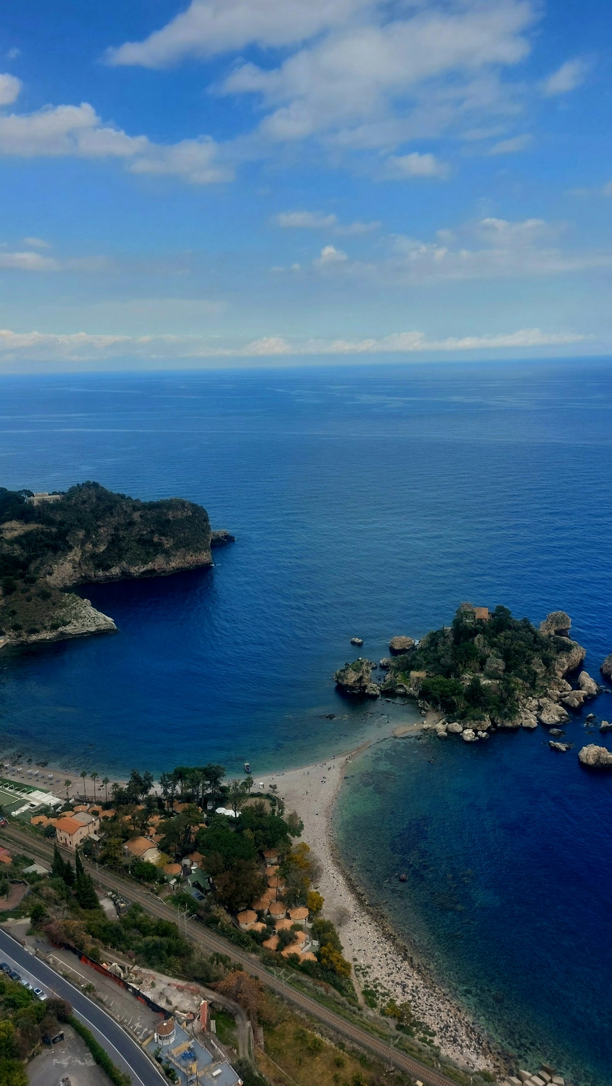 Aerial view of Taormina's Isola Bella bay and the rocky Sicily coastline