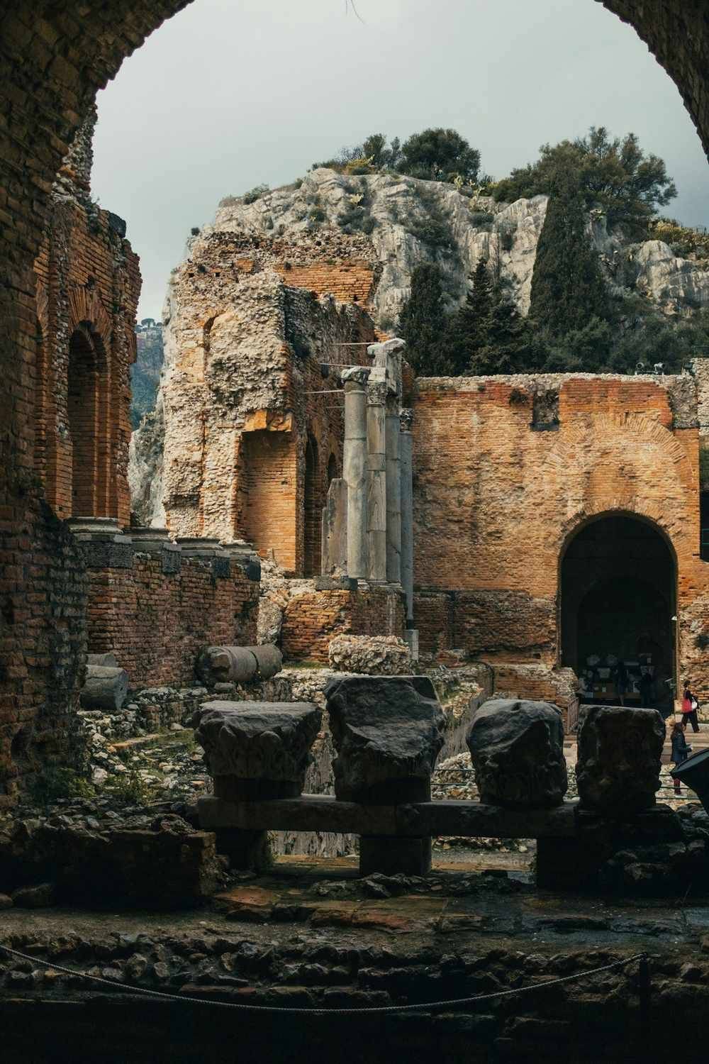 The ancient Greek Theatre of Taormina with Mount Etna in the background and the Ionian Sea below