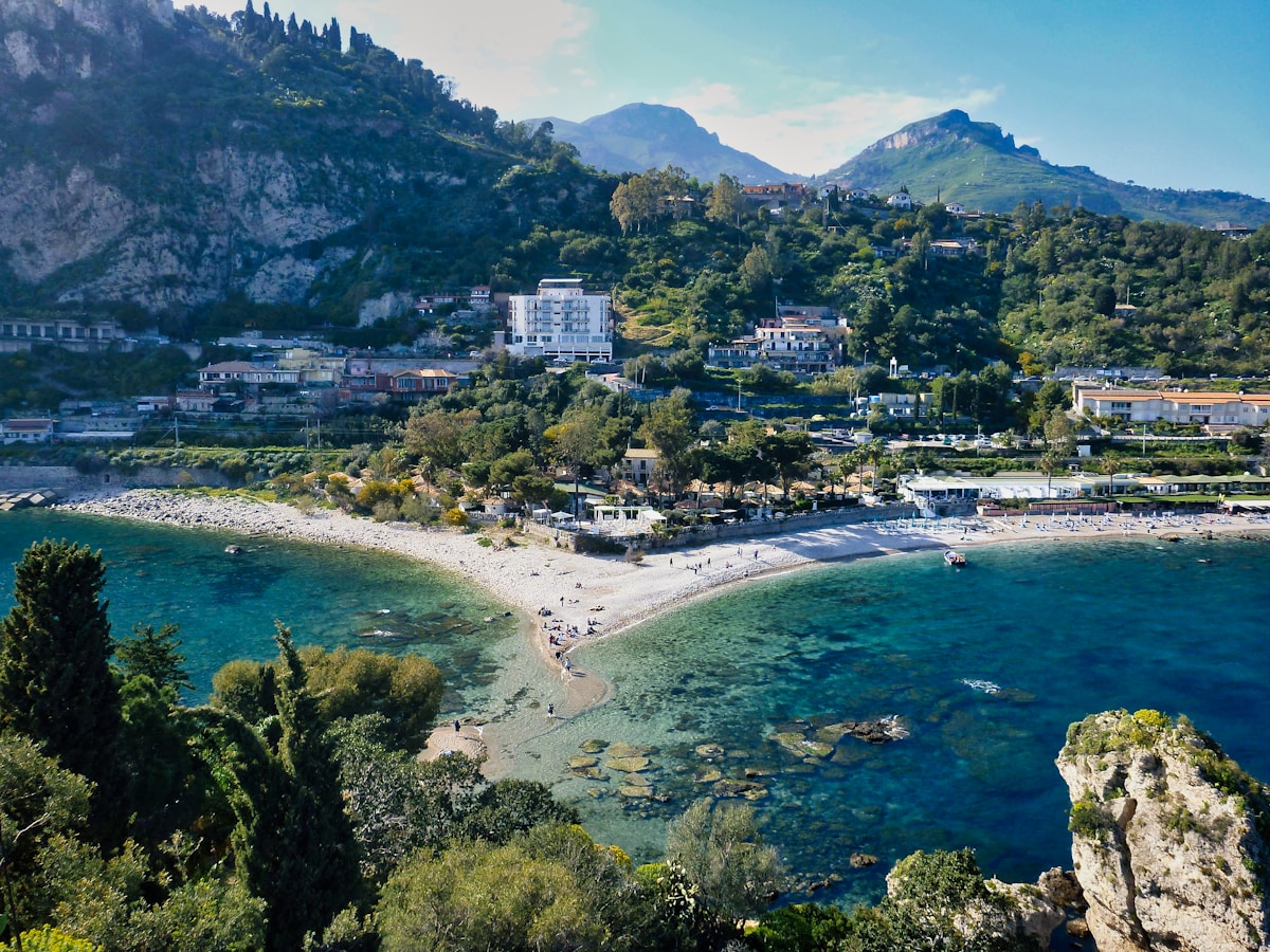 Aerial view of Isola Bella bay and the Taormina coastline with turquoise water, Sicily, Italy