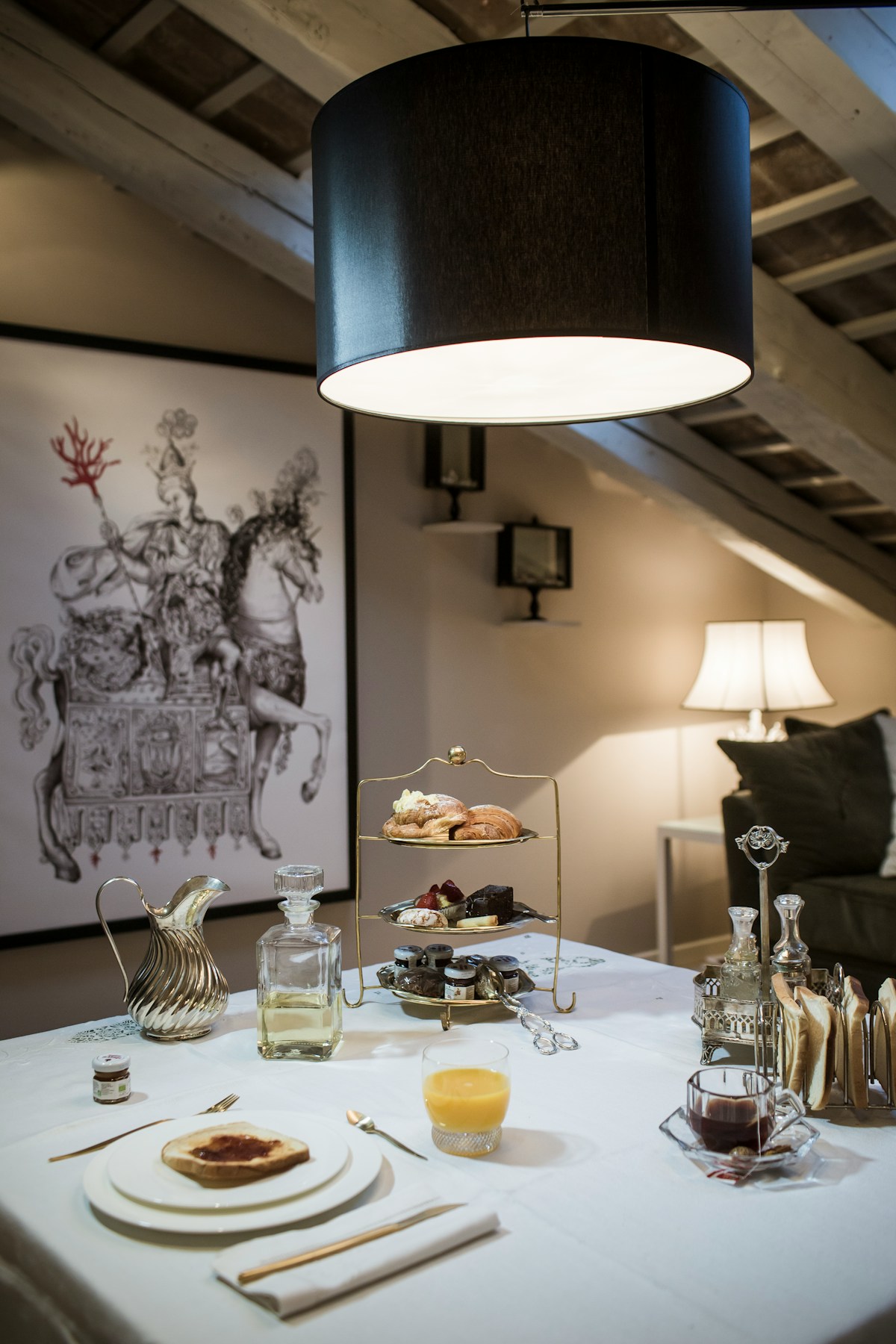 Elegant hotel breakfast table with tiered pastry stand and orange juice, Trieste, Friuli-Venezia Giulia, Italy